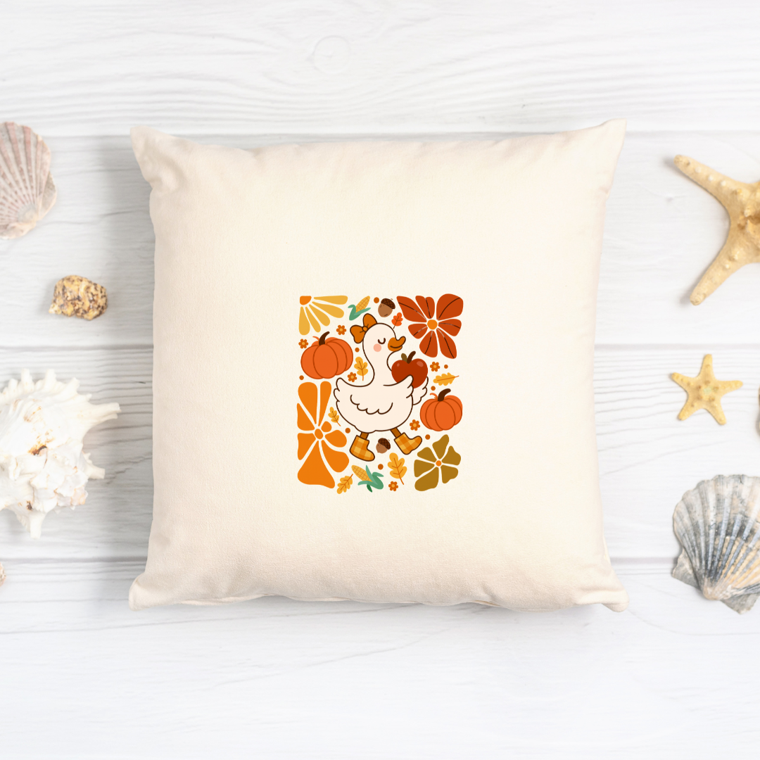 Decorative pillow with a colorful autumn design featuring a turkey and leaves on a white background.