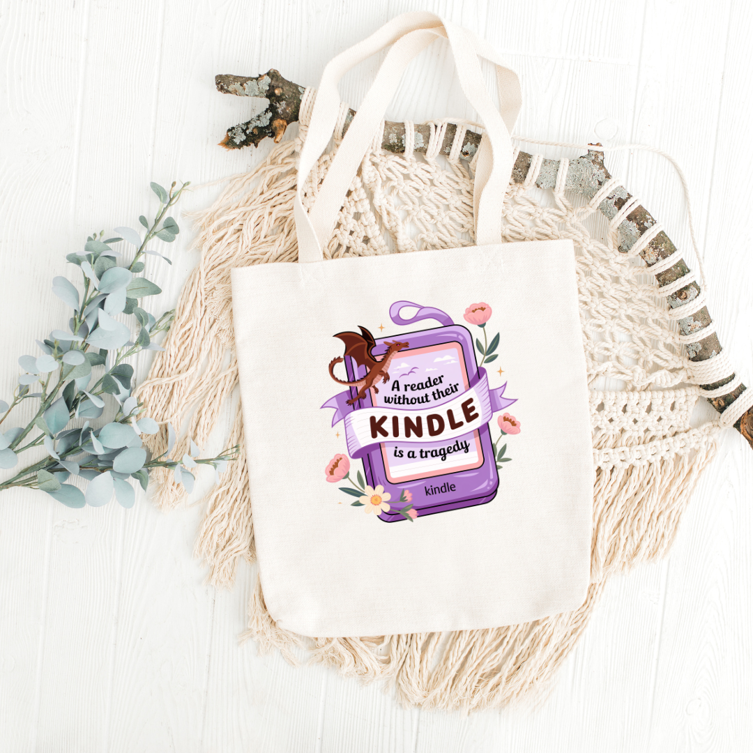 Tote bag with 'Kindle' graphic and text on a woven surface with branches and leaves.